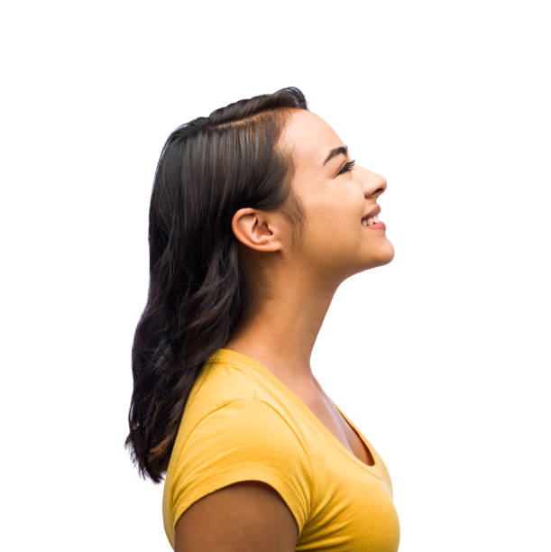 Side view of one young woman Side view of one young woman smiling in isolated on white background shot looking up photos stock pictures, royalty-free photos & images