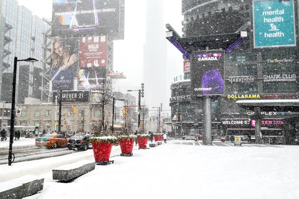 Yonge-Dundas Square in snow in Toronto. The Toronto, Canada - February 27, 2019: Yonge-Dundas Square in snow in Toronto. The Yonge-Dundas intersection is one of the busiest in Canada. toronto dundas square stock pictures, royalty-free photos & images