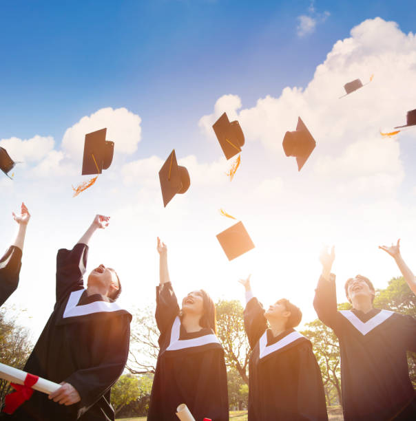 istock happy students throwing graduation caps in the Air 1134384451