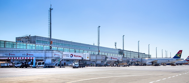 Johannesburg, South Africa, 28th February - 2019: Exterior view of international airport with planes waiting at terminal building.