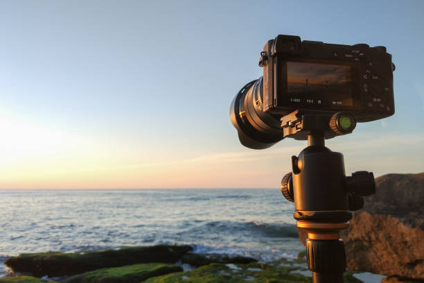 istock Mirrorless camera on a tripod by the sea 1134392880