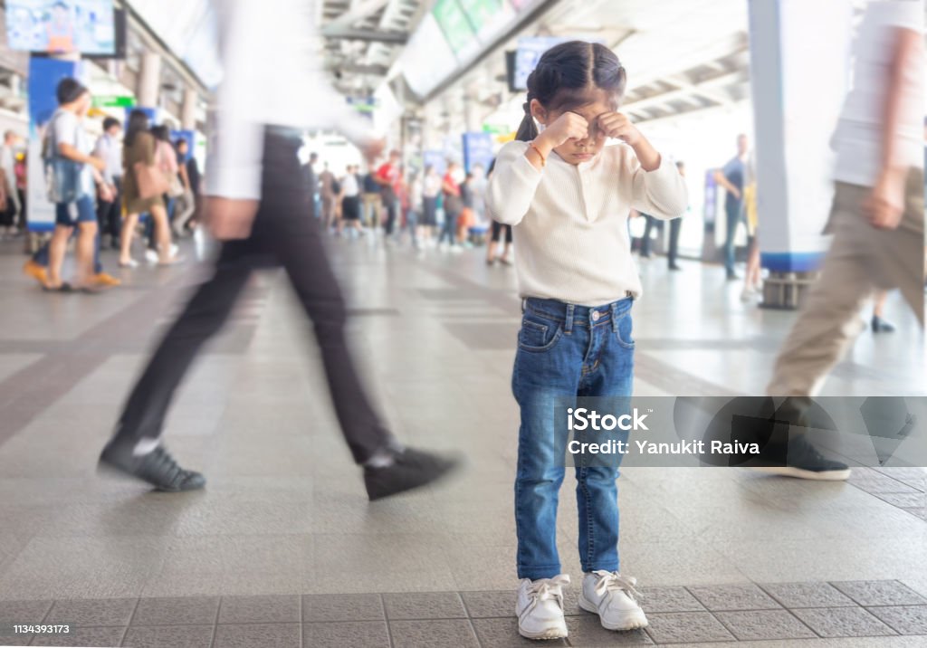 kid crying to lost parent on sky train station. Child Stock Photo