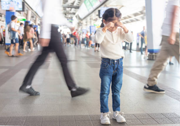 kid crying to lost parent on sky train station. kid crying to lost parent on sky train station. kidnapping photos stock pictures, royalty-free photos & images