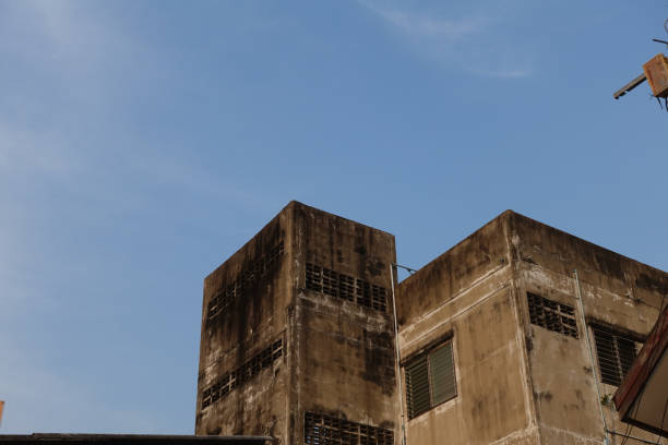 Old painted top floor of building and sky background