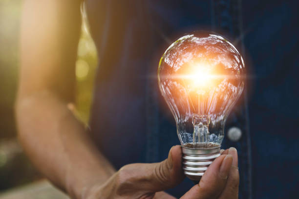 istock Hand holding light bulb for energy power concept in nature background. 1134404726