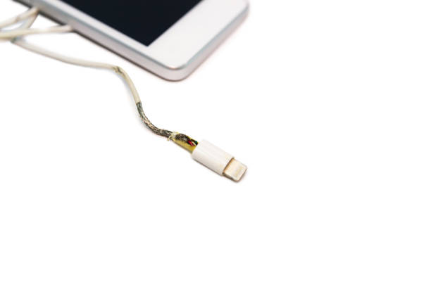 istock danger unsafe cable Phone Charger Lack of damage on white background 1134404796