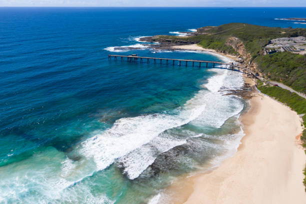 Catherine Hill Bay Central Coast NSW Australia - Aerial View Aerial view of Catherine Hill bay showing the beach and the old coal loading pier. This area was historically a coal mining area but is now enjoyed for its coast and beaches. newcastle new south wales photos stock pictures, royalty-free photos & images