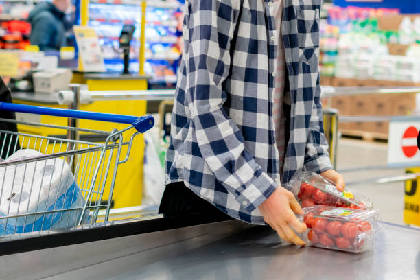 istock young customer put products in a basket b 1134407367