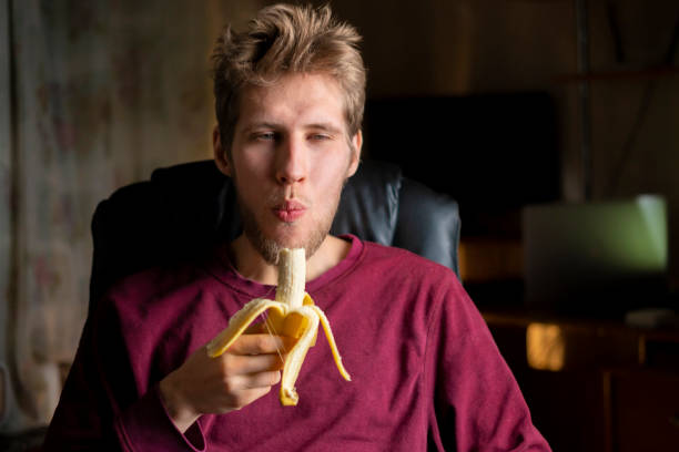 istock person eat fresh banana with emotions on face b 1134409200