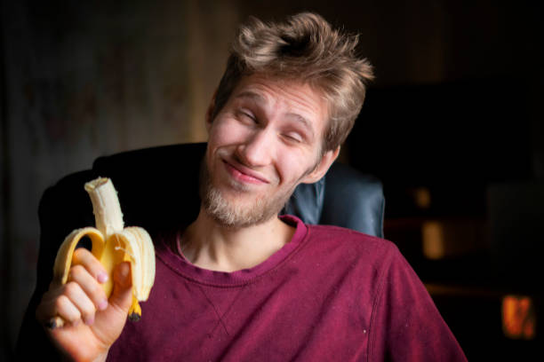 istock person eat fresh banana with emotions on face b 1134409204
