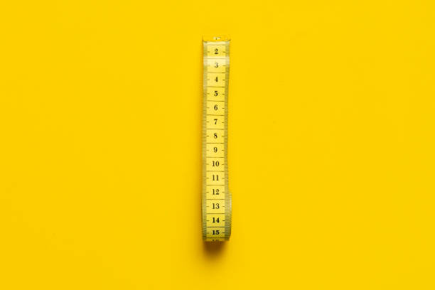 istock measuring tape isolated on yellow background isolated b 1134409263