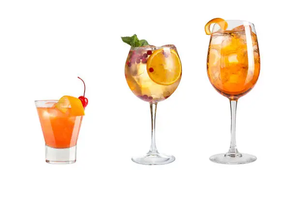 Photo of A variety of alcoholic drinks, beverages and cocktails on a white background. Three different drinks with fruits and berries.