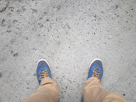 Female feet in slippers on a wooden deck. Top view.