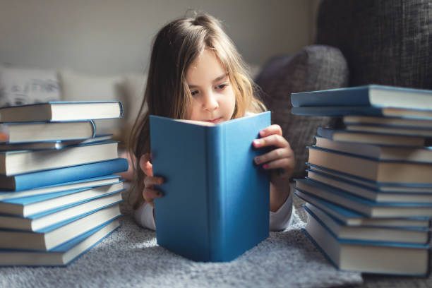 istock Cute Little girl reading book 1134414143