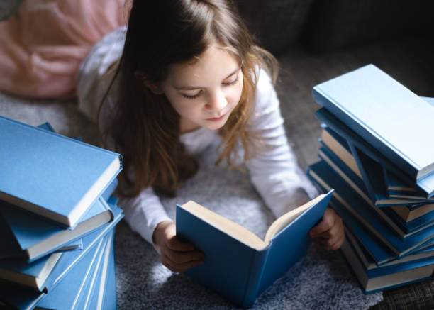 istock Cute Little girl reading book 1134415167