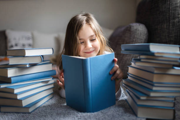 istock Cute Little girl reading book 1134415176