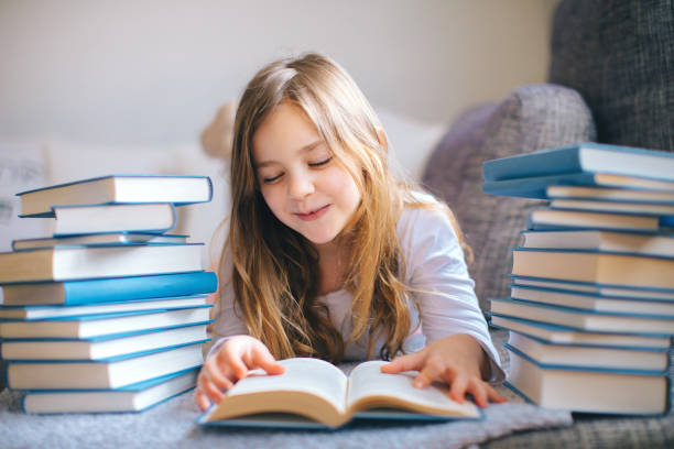 istock Cute Little girl reading book 1134415901
