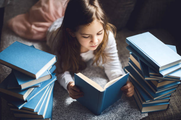 istock Cute Little girl reading book 1134416564