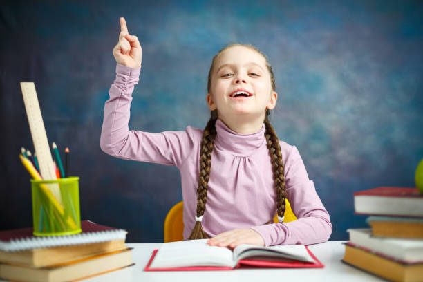 istock Little Primary Schoolgirl Read Book Study Portrait 1134418054