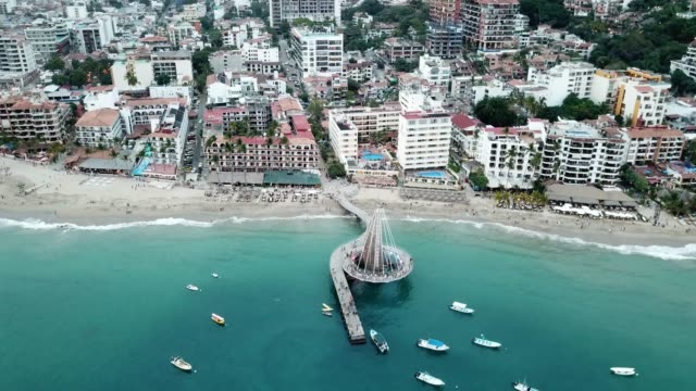An Aerial View Of El Malecon Boardwalk, Muelle Pier And City Of Puerto Vallarta, Mexico