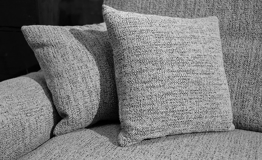 two gray pillows also the couch