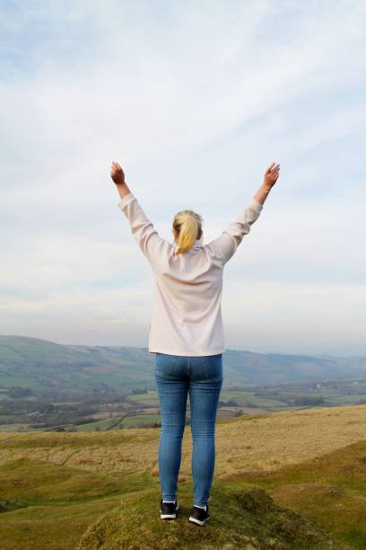 istock young woman with arms outstretched on mountain 1134426161