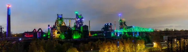 Old factory buildings illuminated at night, Landscape park, Duisburg North, Germany