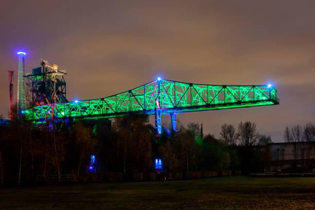 istock Old factory crane illuminated at night 1134426452