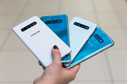 Belgrade, Serbia - February 27, 2019: New Samsung Galaxy S10 mobile smartphones are displayed from rear sides in hand on isolated background.
