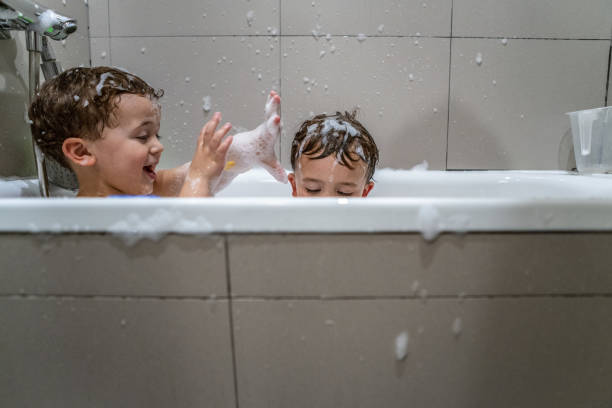 istock Brothers playing in the bathtub 1134429459