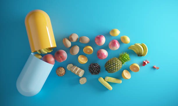 Vitamin Supplements An opening capsule and coming through foods, fruits. ( 3d render ) pill prescription capsule prescription medicine stock pictures, royalty-free photos & images