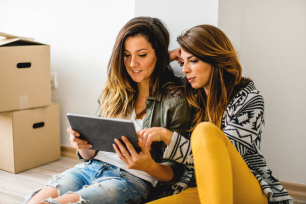 istock Lesbian couple looking at digital tablet 1134431363