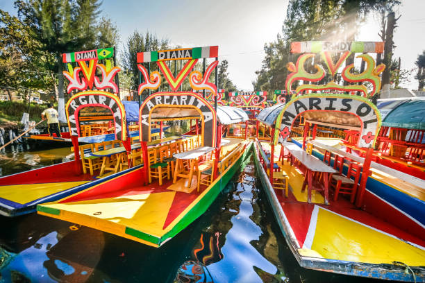 Some colorful and picturesque Trajineras boats moored in Lake Xochimilco in southern Mexico City stock photo