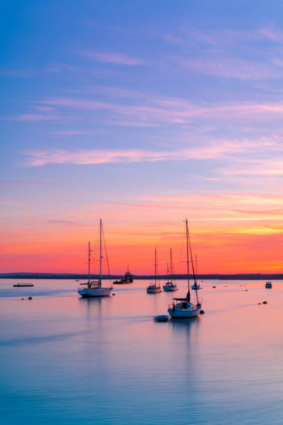 sunset over poole harbour yachts - poole fotografías e imágenes de stock