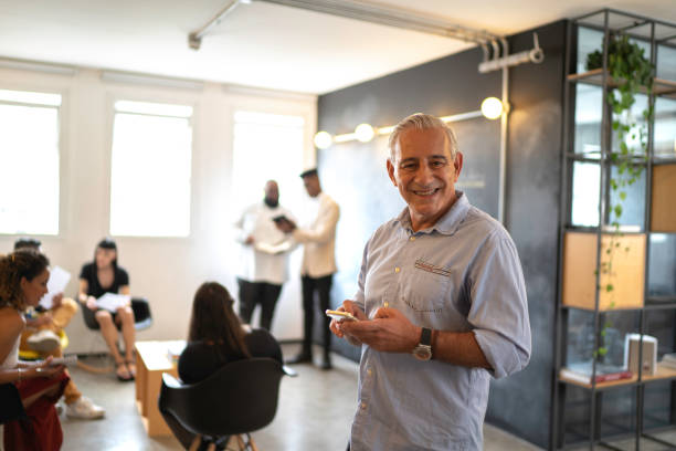 istock Senior businessman using mobile at modern startup company 1134435939