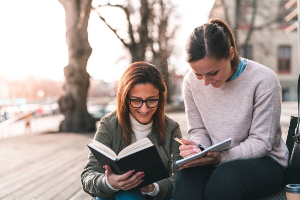 istock Two female students are working together on campus 1134436016