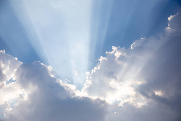 istock beautiful sun beam behind cloud and blue sky 1134436856