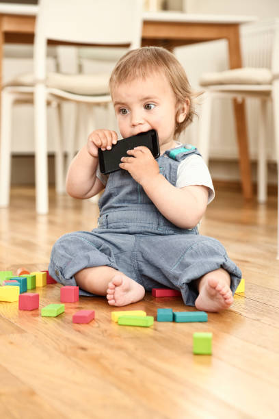 istock Litlle boy sitting on the floor playing with toys 1134436938