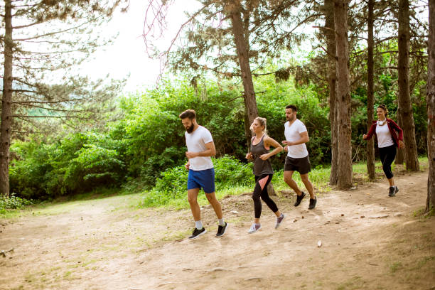 istock Group of young people run a marathon through the forest 1134438382