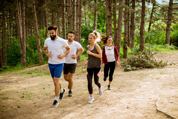 istock Group of young people run a marathon through the forest 1134438391
