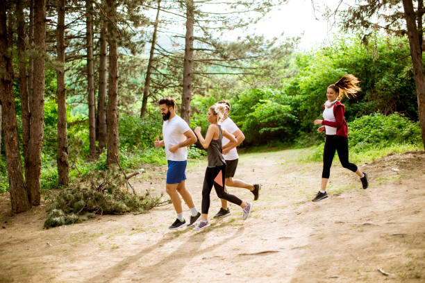 istock Group of young people run a marathon through the forest 1134438408