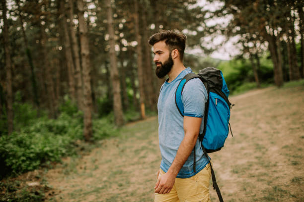 istock Active healthy man hiking in beautiful forest 1134438443