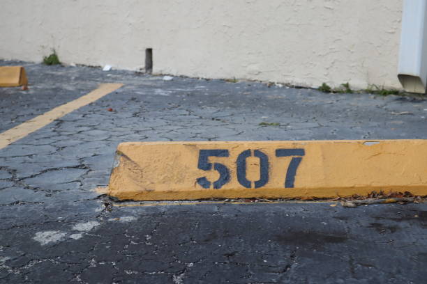 istock number 507 black on yellow. asphalt on the background. black number stencil painted on backdrop, number 507; number five hundred seven 1134441580