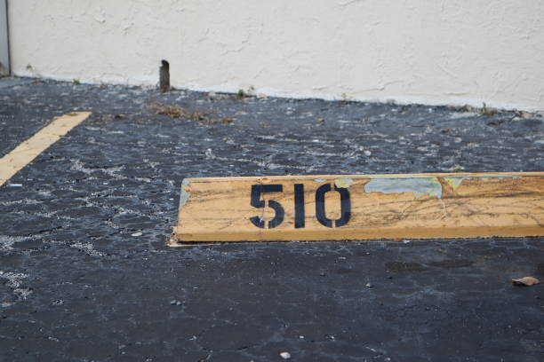 istock number 510 black on yellow. asphalt on the background. black number stencil painted on backdrop, number 510; number five hundred ten 1134442155