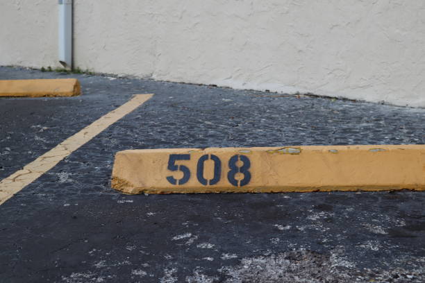 istock number 508 black on yellow. asphalt on the background. black number stencil painted on backdrop, number 508; number five hundred eight 1134442156