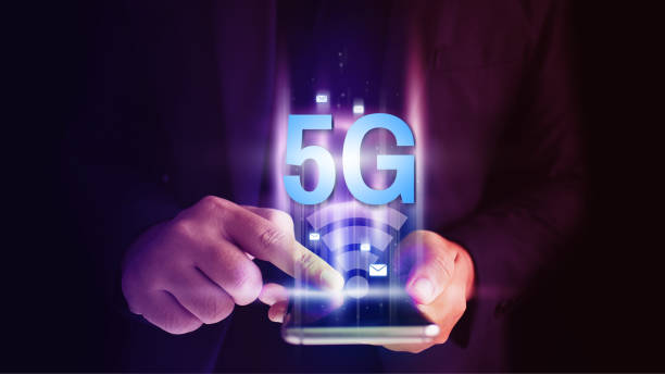 istock Business man using mobile smartphone with 5G icons flow on virtual screen concept. 5G High speed internet network. 1134443232