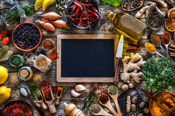 Spices and herbs frame shot from above on rustic wooden table