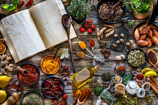 istock Cooking concepts: Cookbook with spices and herbs shot from above on rustic wooden table 1134444049