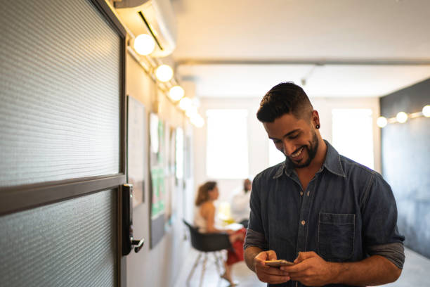 istock Young businessman using mobile at modern company office 1134444441