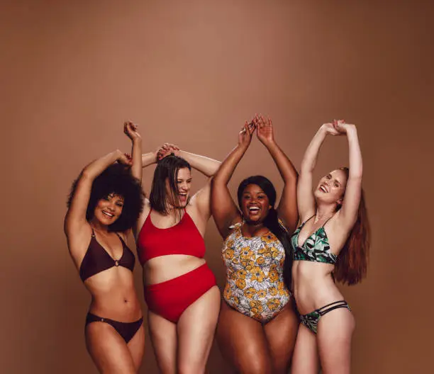 Photo of Multi-ethnic women in swimwear enjoying themselves